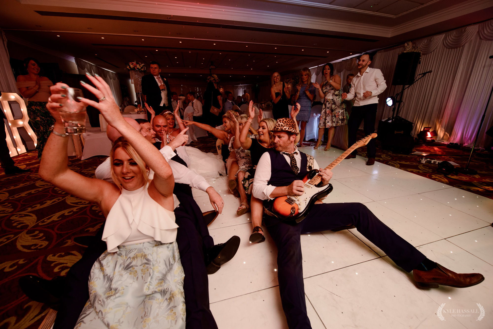 Manchester_wedding_band guitarist sat on the floor playing the guitar