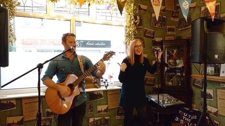 Singer and guitarist laughing